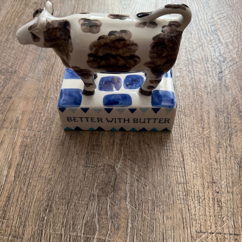 Ceramic Hand-Painted Cow Figurine‎ on Blue and White Base 'Better With Butter'
